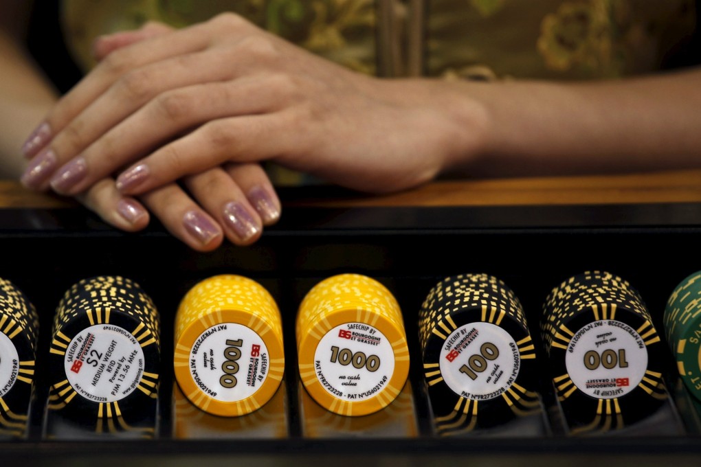 A croupier sits in front of a gaming table at Global Gaming Expo Asia in Macau in this June 8, 2011 file photo. Gambling revenue in the Chinese territory of Macau is expected to drop as wealthy gamblers steer clear of the country's only legal casino hub. Photo: Reuters