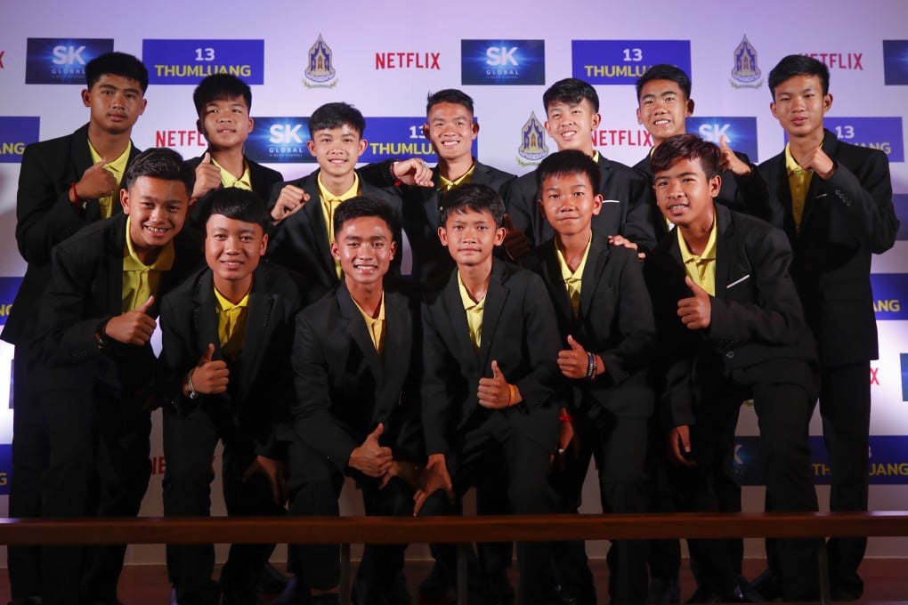 Members of the Wild Boars soccer team and their coach at an event to announce the Netflix deal. Photo: EPA