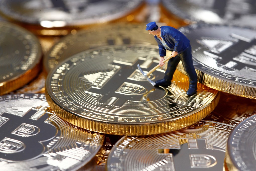 A small toy figure is seen on representations of the bitcoin virtual currency in this illustration picture. Photo: Reuters