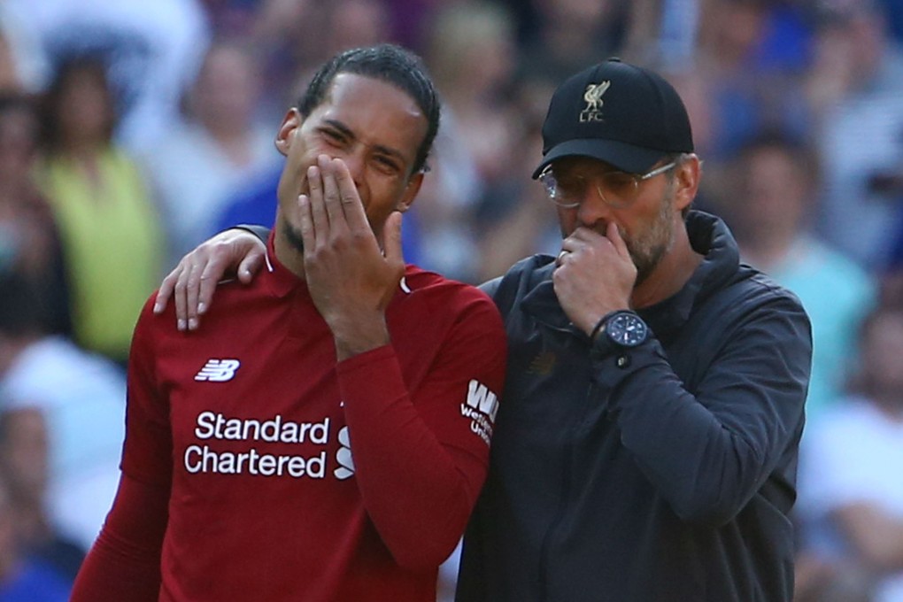 Liverpool manager Jurgen Klopp (right) talks with defender Virgil van Dijk after victory over Cardiff City. Photo: AFP