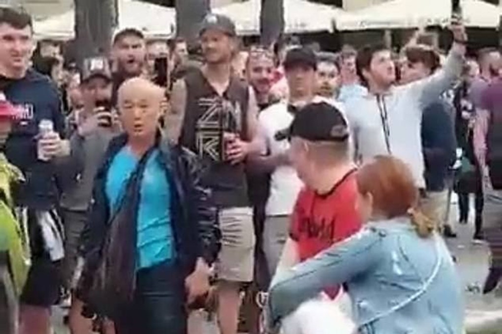 An elderly Asian man appears distressed after being pushed into the Placa Reial fountain by a Liverpool fan in Barcelona. Photo: Twitter