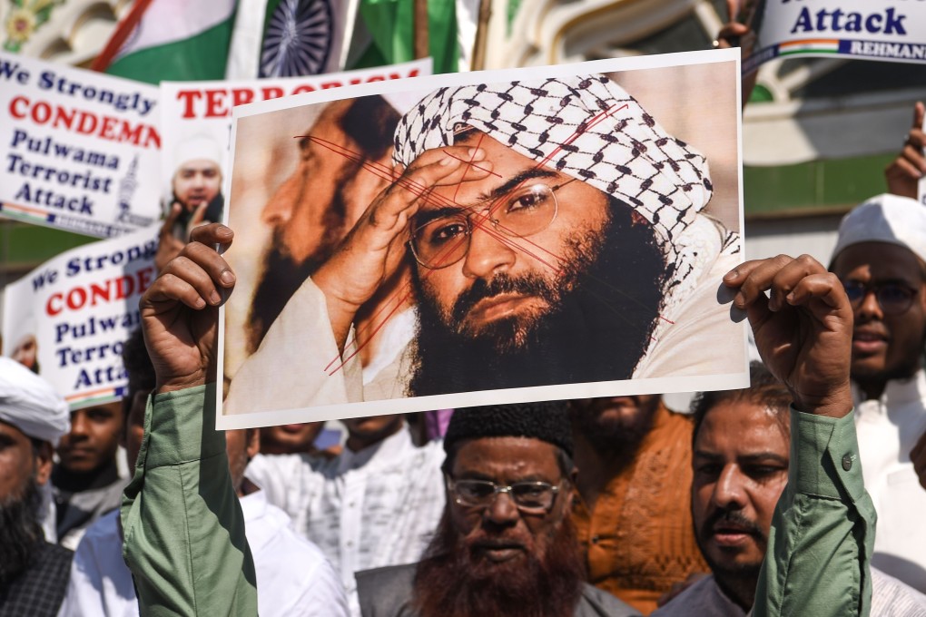 Indian Muslims holding a photo of Masood Azhar shout slogans against Pakistan after a terror attack in Kashmir. Photo: AFP