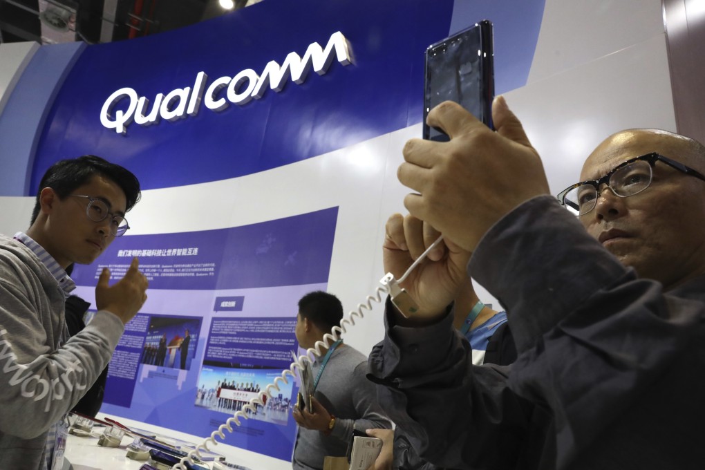 Attendees look at technology from Qualcomm at the China International Import Expo in Shanghai in 2018. Photo: AP