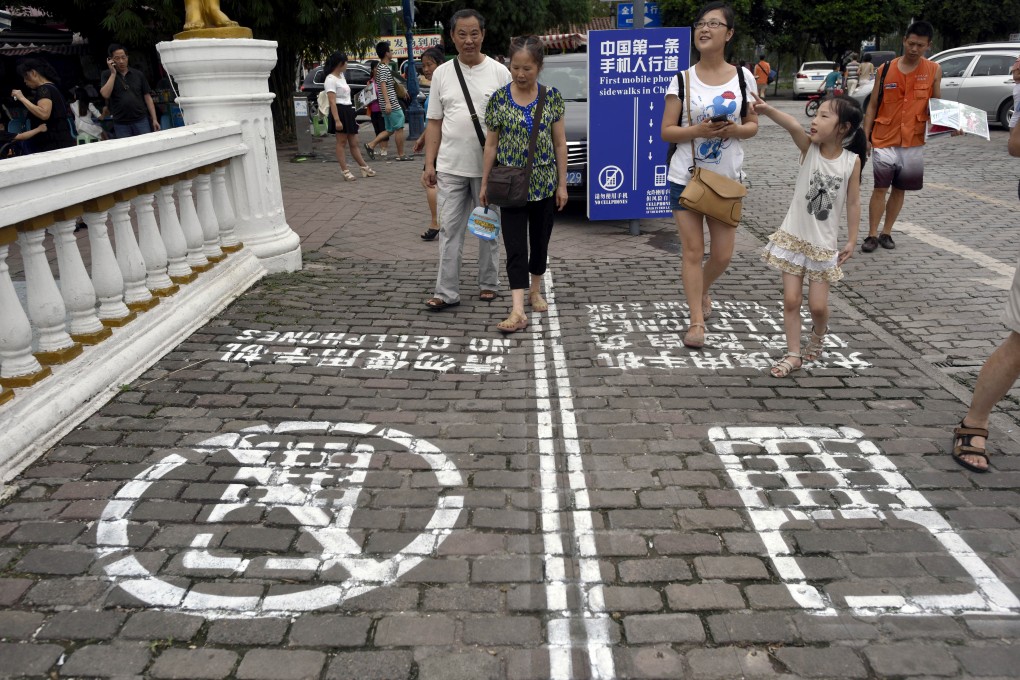 Chongqing, in southwest China, has introduced a pavement with a separate lane for text-walkers. Photo: AP