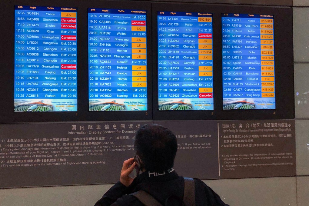 A passenger checks the departures board at Beijing’s international airport on Saturday. Photo: Josephine Ma