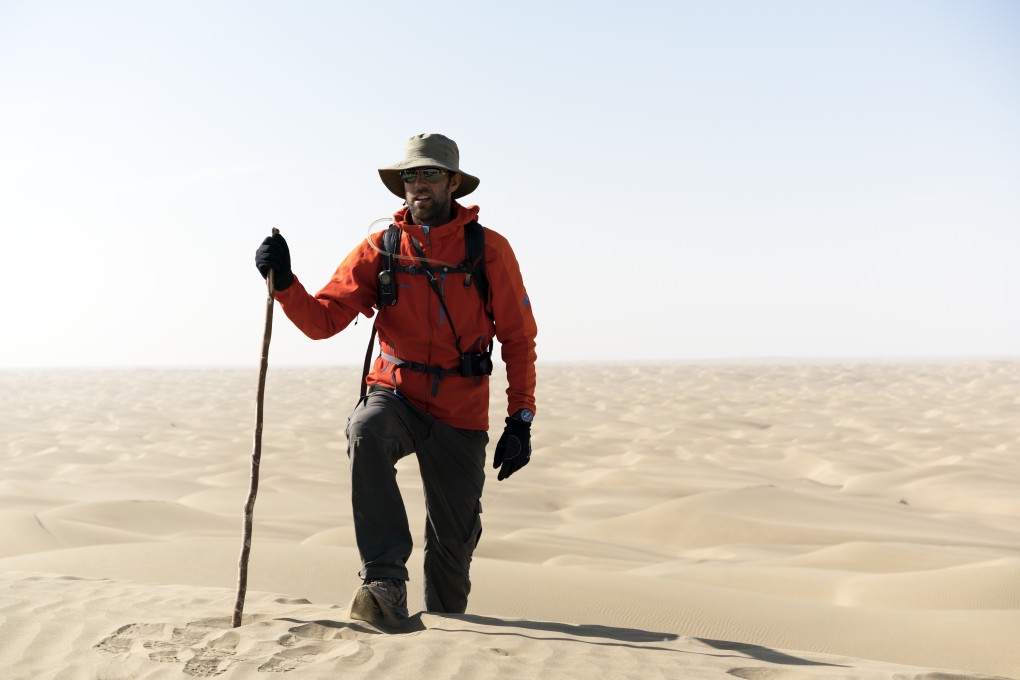 Ryan Pyle treks through the Taklamakan Desert in China while filming his television series Extreme Treks on BBC Earth.