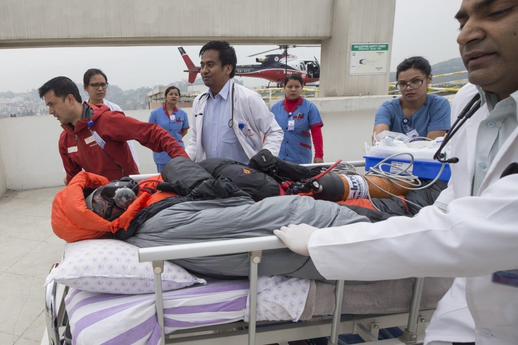 Malaysian climber Chin Wui Kin is transported from a helicopter at Medcity hospital in Nepal. Photo: EPA-EFE
