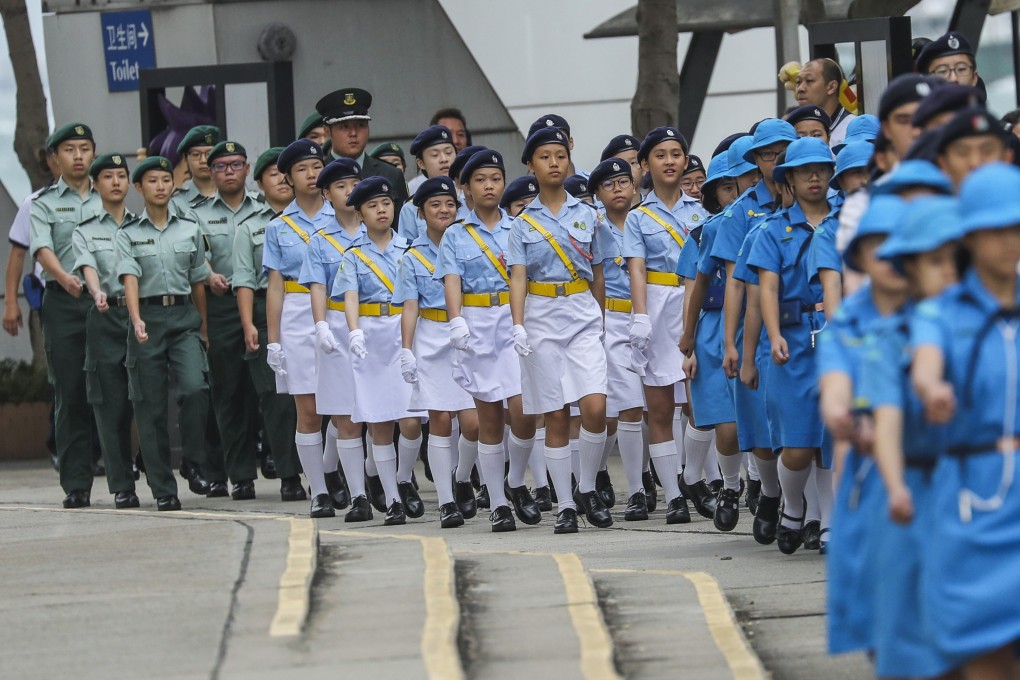 The Hong Kong Road Safety Patrol marches as the flag-raising ceremony for the 100th anniversary of the May Fourth Movement at Golden Bauhinia Square in Wan Chai on Sunday. Photo: Winson Wong