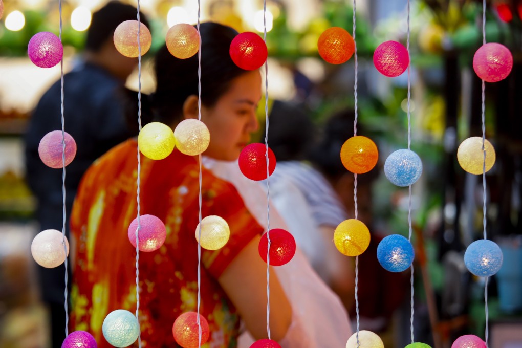 A visitor browses at an international trade fair in Bangkok in April. Thailand draws much interest from various developed countries as an economic partner, and it should set policies to maintain negotiation power. Photo: EPA-EFE