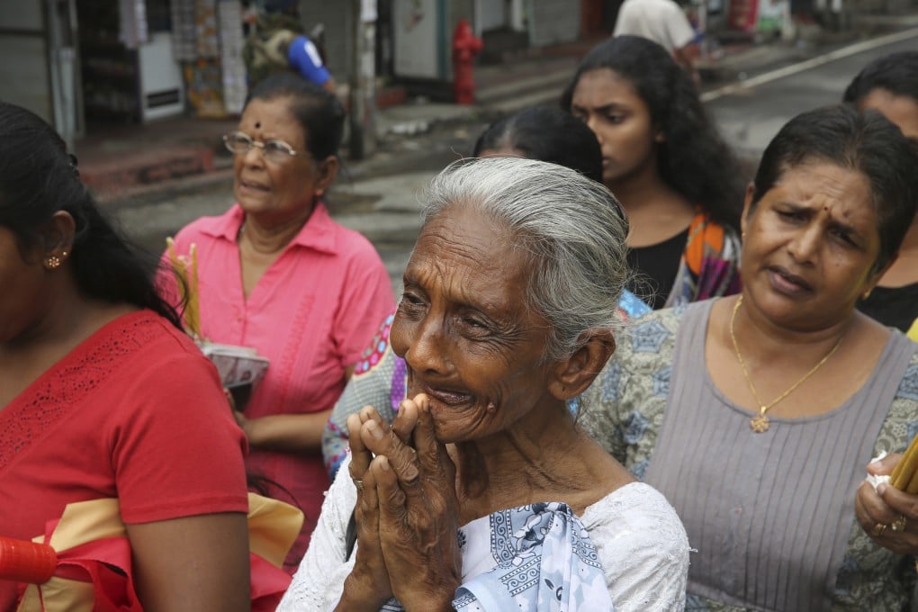 Sri Lankans light candles and pray outside St Anthony’s Church in Colombo, Sri Lanka. Photo: AP