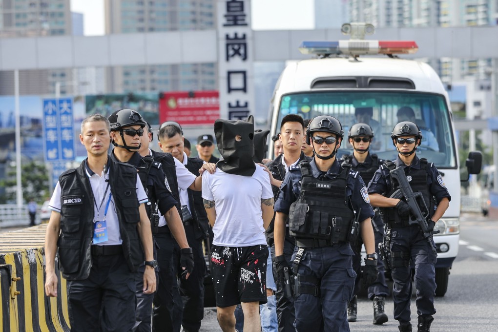 Guangdong police hand over three suspects in a 2018 robbery case to Hong Kong police at Huanggang port. Photo: Edward Wong