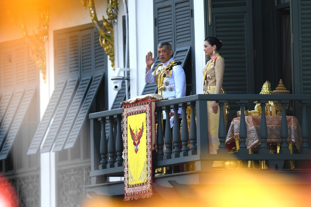 King Maha Vajiralongkorn and Queen Suthida wave to the crowd from a balcony of the Grand Palace in Bangkok. Photo: AFP