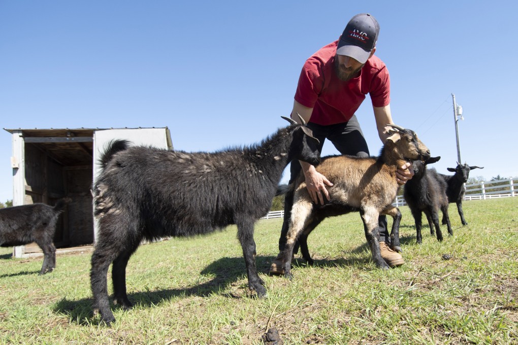 Michael Behenna with some goats on his farm in Oklahoma. Photo: The Washington Post