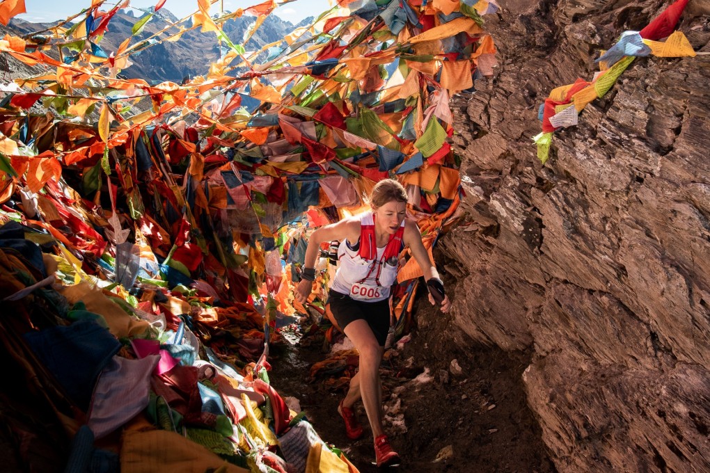 Megan Kimmel, the eventual winner, runs through mountains of prayer flags. The local culture is one reason to make the trip. Photo: Kirk Kenny/MRSWS/Studio Zag