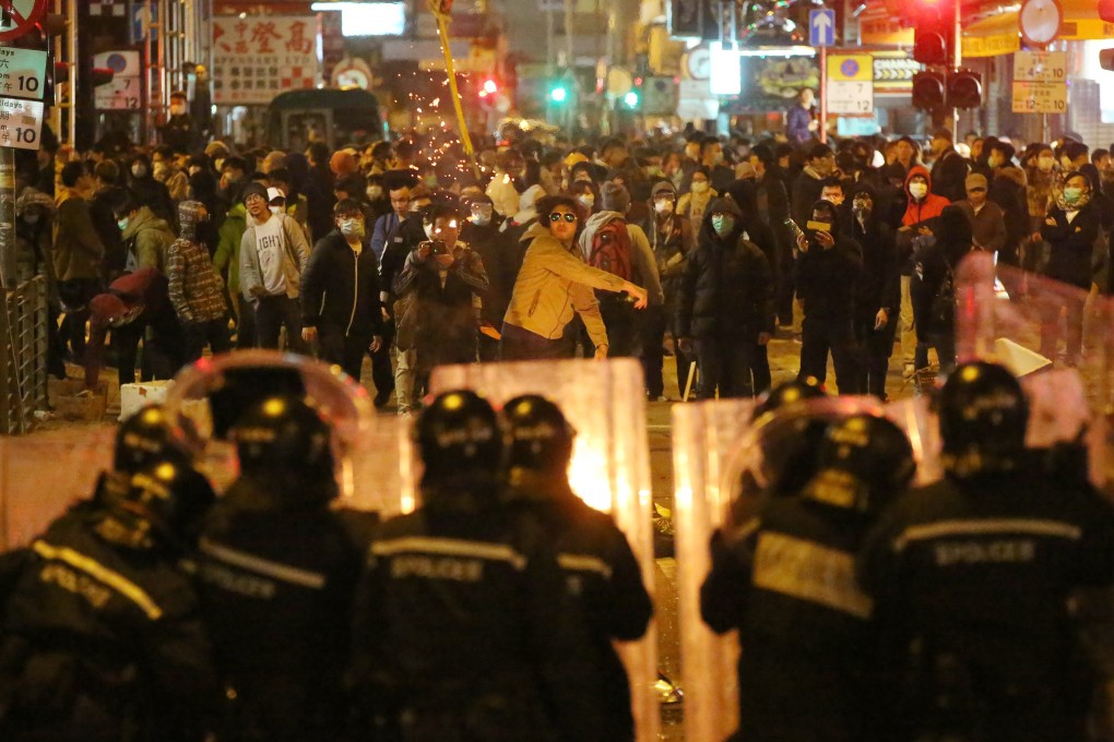 Police confront protesters in Mong Kok during a clash over illegal food stalls during the three-day Lunar New Year holiday in February 2016. Photo: Edward Wong