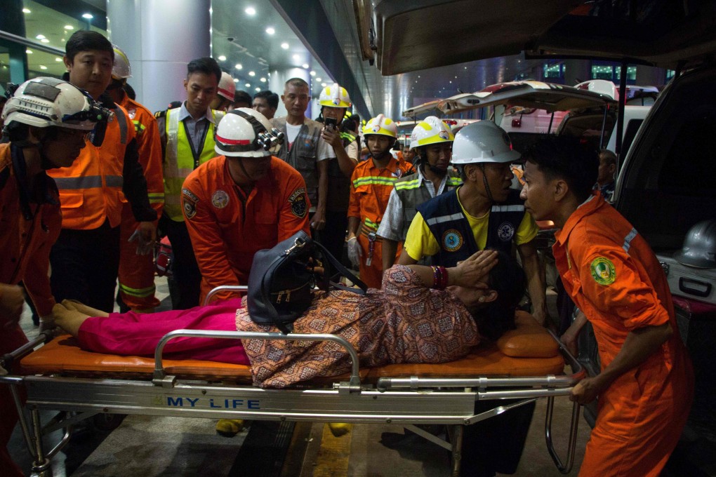 Emergency responders transport an injured passenger. Photo: AFP