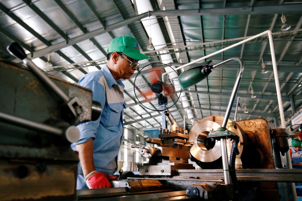 A man works at a mechanical factory in Hanoi. Photo: Reuters
