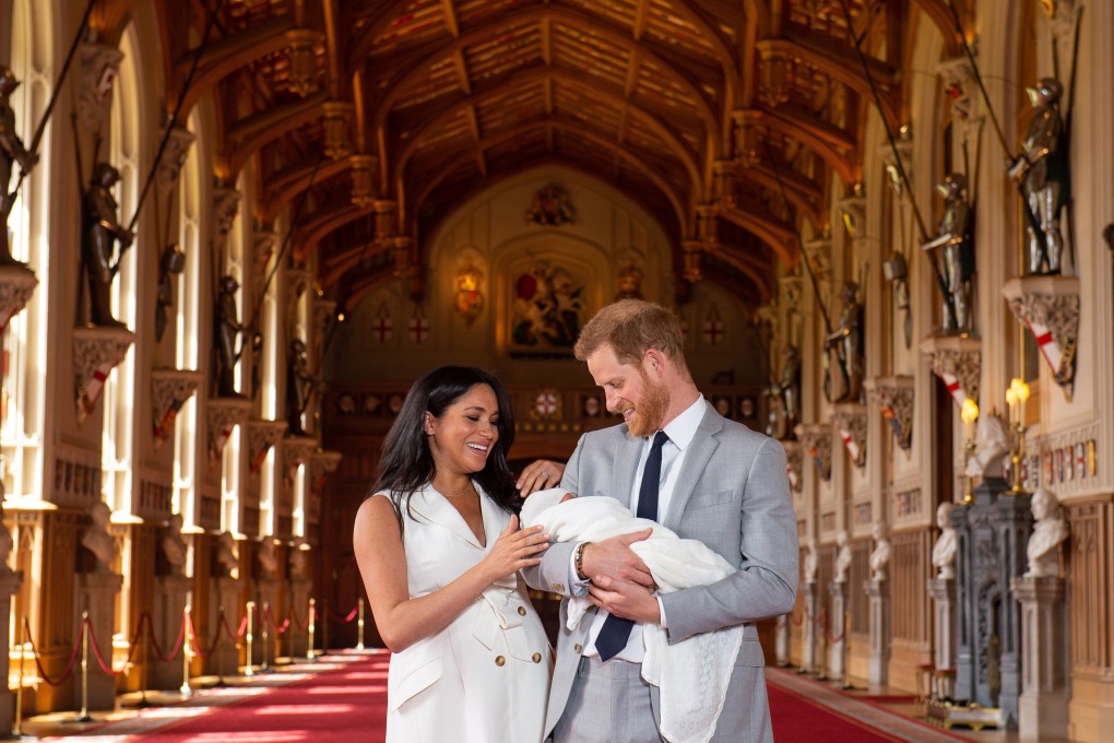Prince Harry (R) and Meghan, the Duchess of Sussex pose together with their newborn son in Winsdor. Photo: EPA-EFE