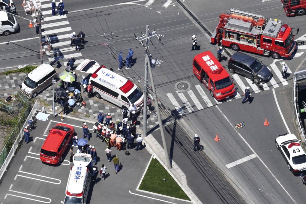 Police investigates the site where a car slammed into a group of 16 people, mostly kindergarten children. Photo: AP