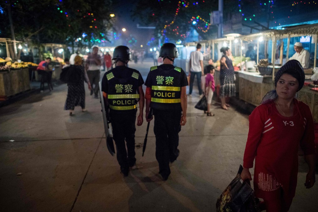 Police patrol a night food market near the Id Kah Mosque in Kashgar in June 2017. Photo: AFP