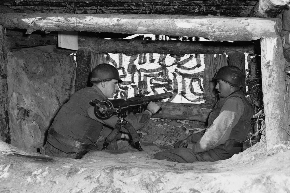 US servicemen in a camouflaged bunker in Korea, 1953. Photo: AP