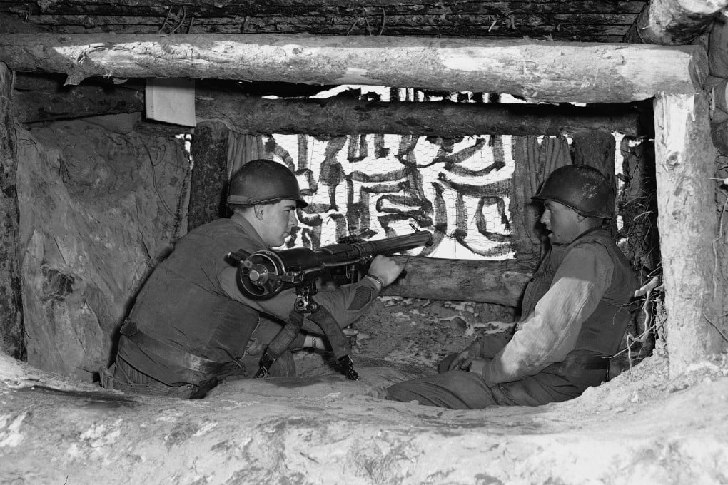 US servicemen in a camouflaged bunker in Korea, 1953. Photo: AP