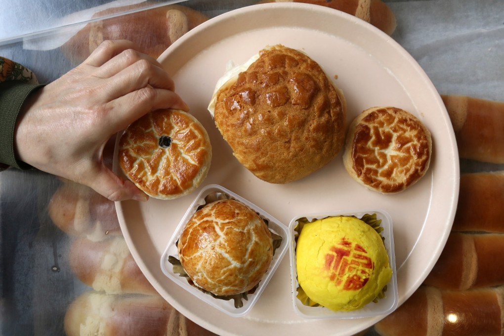 A selection of buns and cakes from Tai Tung Bakery in Yuen Long, Hong Kong, including a pineapple bun (top centre) twice the size of those served at most bakeries, and a variety of “wife cakes”. Photo: Jonathan Wong