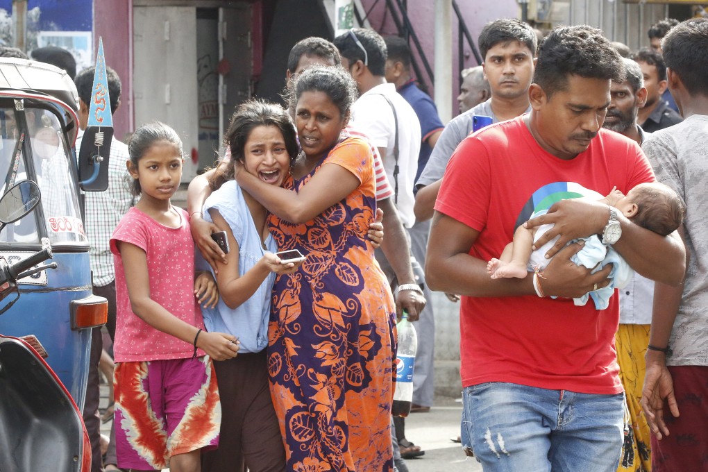 People run to safety after a van is found to contain a suspected explosive device, near St Anthony’s Church in Colombo on April 22. The previous day, nearly 300 people were killed and over 500 injured in a series of blasts in the city during Easter Sunday service. Photo: EPA-EFE