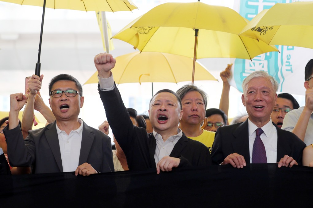 Chan Kin-man, Benny Tai Yiu-ting and Reverend Chu Yiu-ming stand defiantly outside the West Kowloon Law Courts Building in Cheung Sha Wan on April 19 before the sentencing hearing for their roles in the 2014 Occupy movement. Photo: Sam Tsang