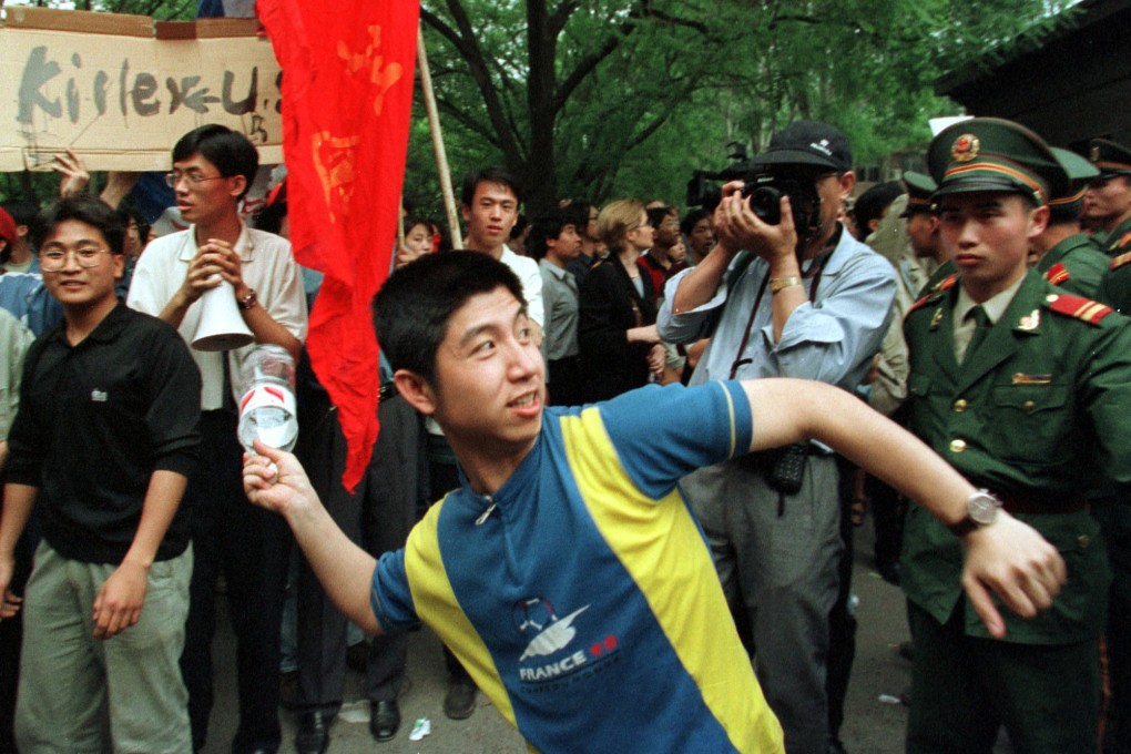 A student throws a bottle at the US embassy in Beijing in a protest against the Nato strike on the Chinese embassy in Belgrade. Photo: AP
