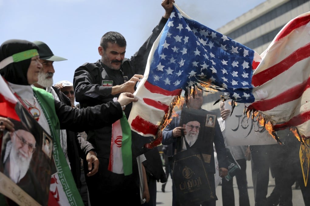 Worshippers burn a home-made US flag during a rally after Friday prayer in Tehran, Iran. Photo: AP