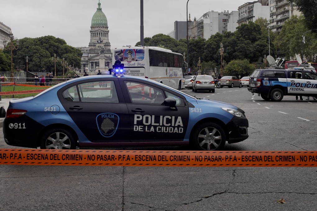 Police cars are parked at the crime scene where Argentine lawmaker Hector Olivares was seriously injured. Photo: AP Photo