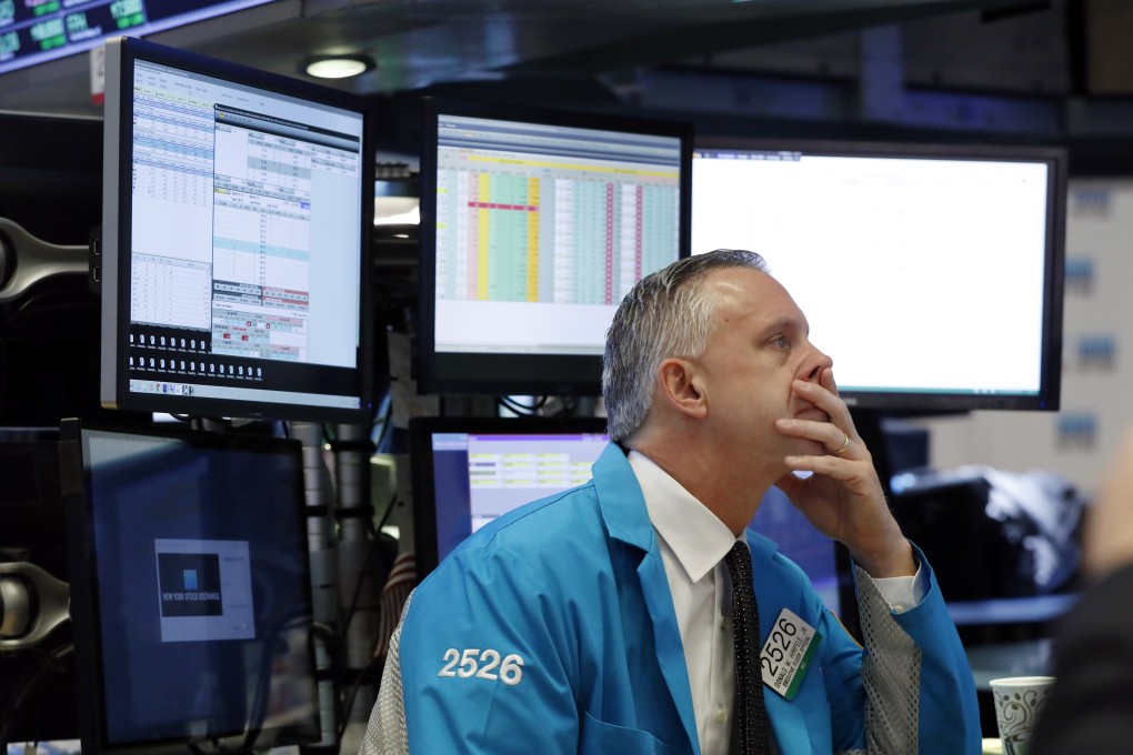 Donald Himpele Jnr works at his post on the floor of the New York Stock Exchange. Volatility has dominated the markets this week, but analysts said investors needed to take the long view. Photo: AP