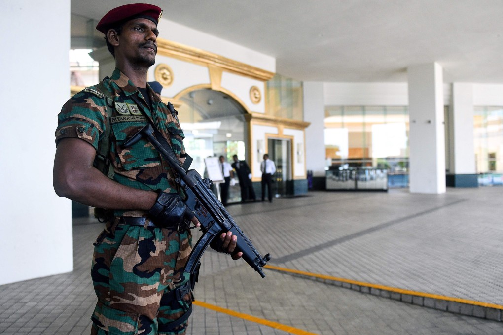A Sri Lankan soldier stands guard at the entrance of the Cinnamon Grand Colombo hotel lobby. Photo: Ishara S. Kodikara/AFP