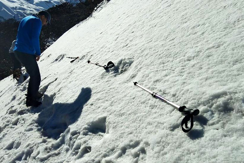 In this handout photo taken by the Indian Army, men measure large foot prints in the snow, sighted by the Indian Army, near the Makalu Base Camp in the North-Eastern Himalayas, which the army’s social media team said were photos of the mythical yeti. Photo: Handout