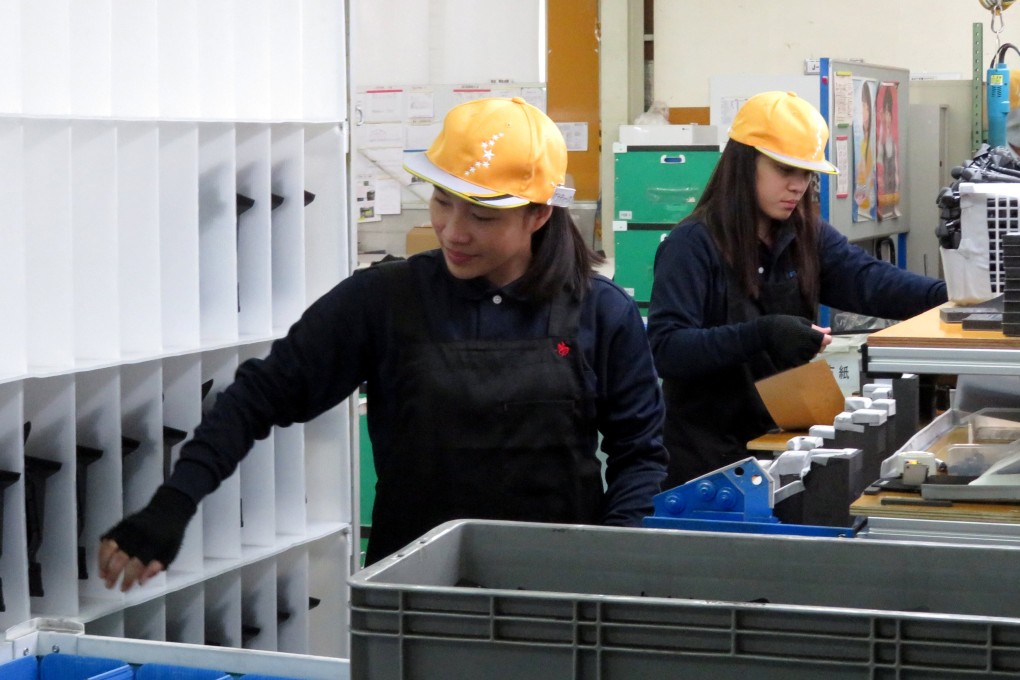 Filipino workers at a car parts factory in Hiroshima prefecture, Japan. Photo: Reuters