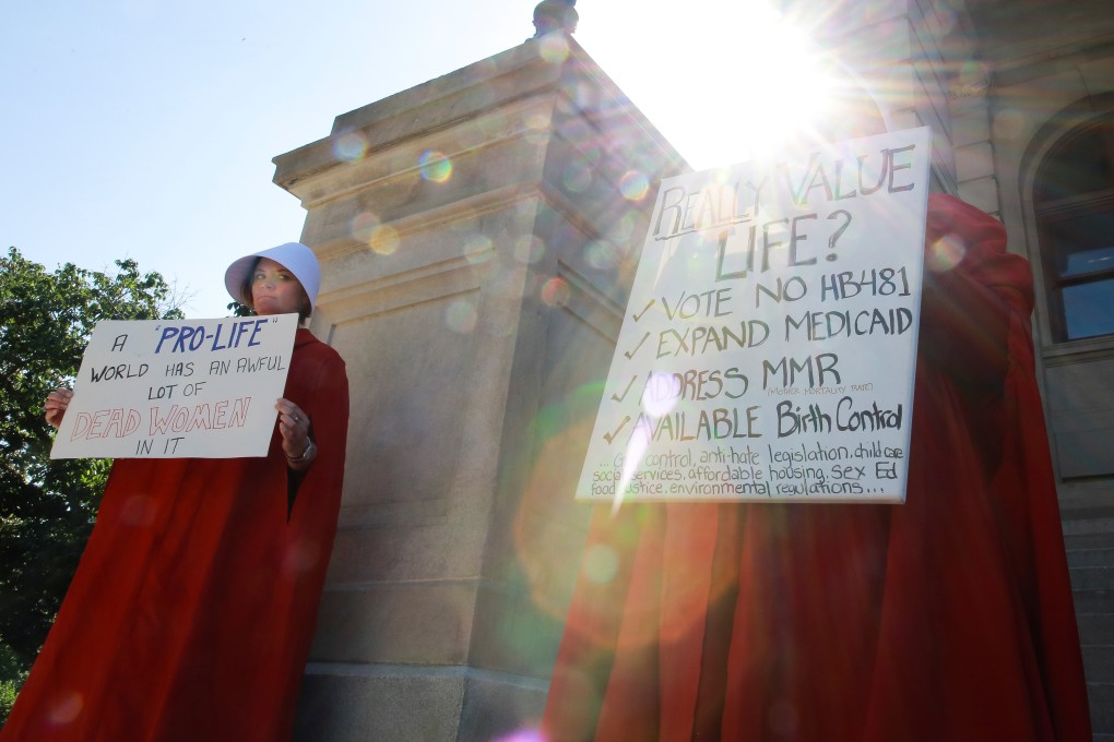 April Houston and Lara Martin hold signs while dressed as Handmaids in protest of Georgia's anti-abortion “heartbeat” bill at the Georgia State Capitol in Atlanta. Photo: Reuters