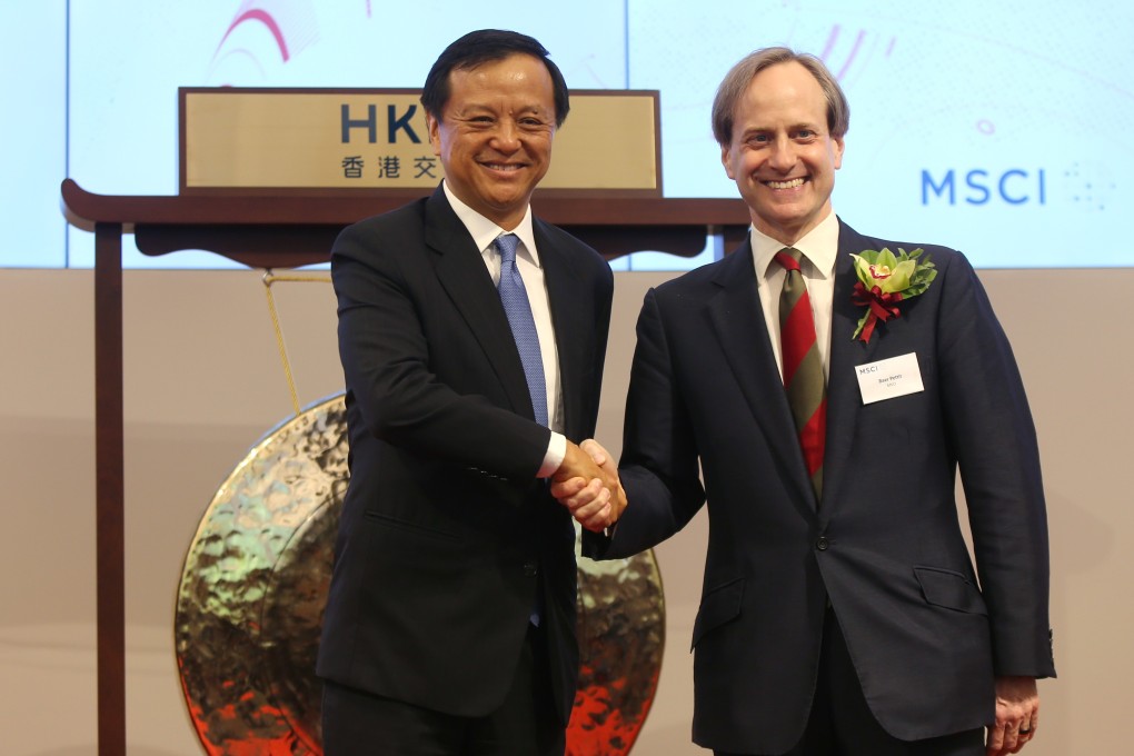 Charles Li, chief executive of Hong Kong Exchanges and Clearing, shakes hands with MSCI president Baer Pettit at MSCI’s A-share inclusion ceremony in May 2018. Photo: Xiaomei Chen