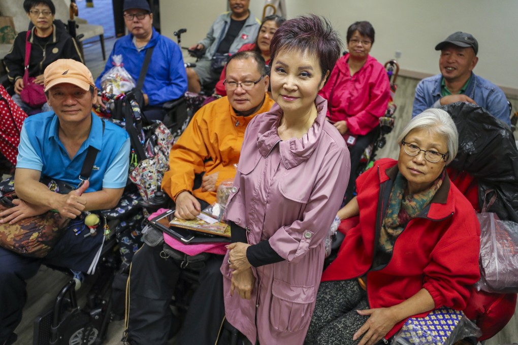 Rehabaid Society CEO Cecilia Lam with patients in wheelchairs. Photo: Winson Wong