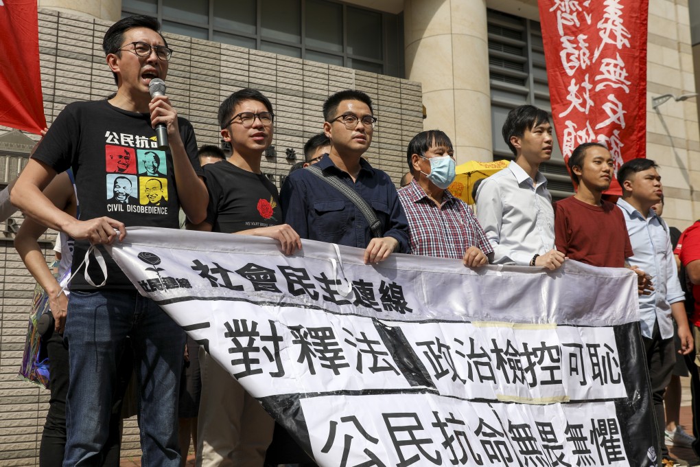 From left to right, Avery Ng, Dickson Chau, Chan Man-wai, Chau Shu-wing, Cheng Pui-lam, Ip Chi-hin and Lo Tak-cheong protest at the West Kowloon Court on Wednesday. Photo: Nora Tam