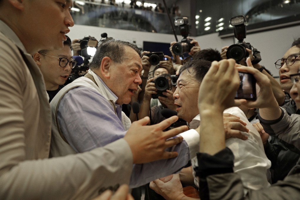 Pro-democracy lawmaker Wu Chi-wai (centre, right) talks to pro-Beijing lawmaker Abraham Razack at a meeting last Saturday that descended into chaos at the Legislative Council. Photo: AP