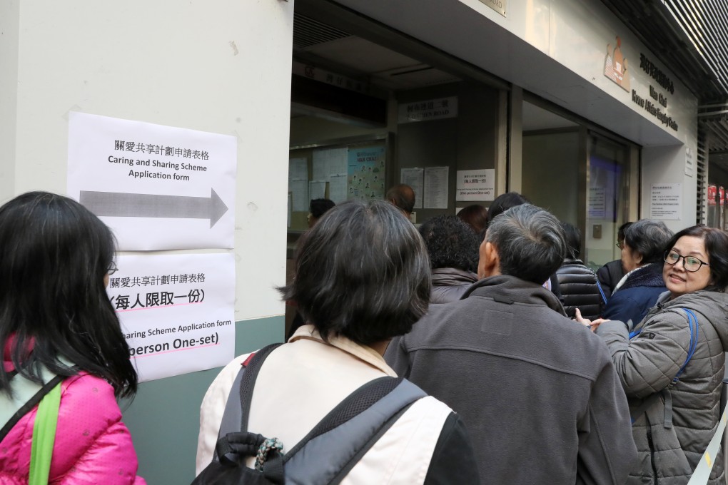 People queue up to collect Caring and Sharing Scheme application forms, at the Wan Chai Home Affairs inquiry Centre in January. Applications closed on April 30. Photo: K.Y. Cheng