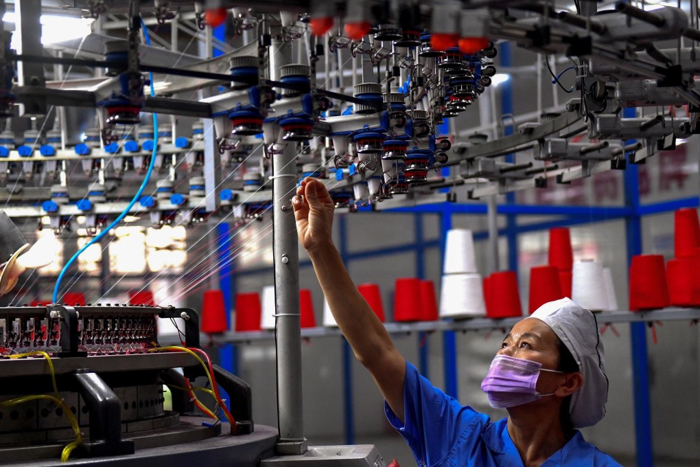 An employee monitoring a circular weaving machine at a textile factory in Shangqiu in China's central Henan province. Photo: Agence France-Presse