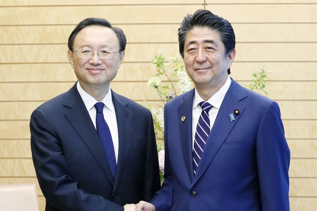 China’s top diplomat Yang Jiechi (left) told Japanese Prime Minister Shinzo Abe he hopes for “healthy, stable” relations between the two countries. Photo: Kyodo