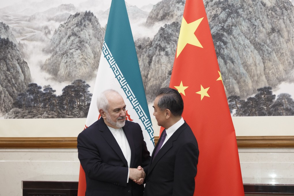 Iranian Foreign Minister Mohammad Javad Zarif (left) is greeted by Chinese Foreign Minister Wang Yi at the Diaoyutai State Guesthouse in Beijing on Friday. Photo: AP