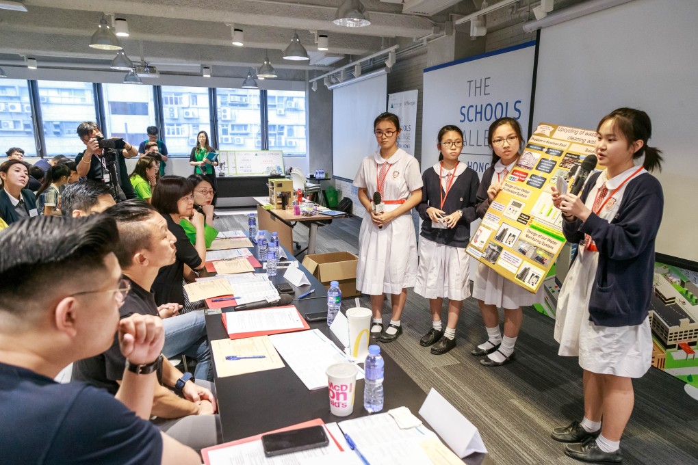 The winning team from Po Leung Kuk Celine Ho Yam Tong College demonstrating their project, which uses activated carbon to purify water. Photo: Hilary Wong