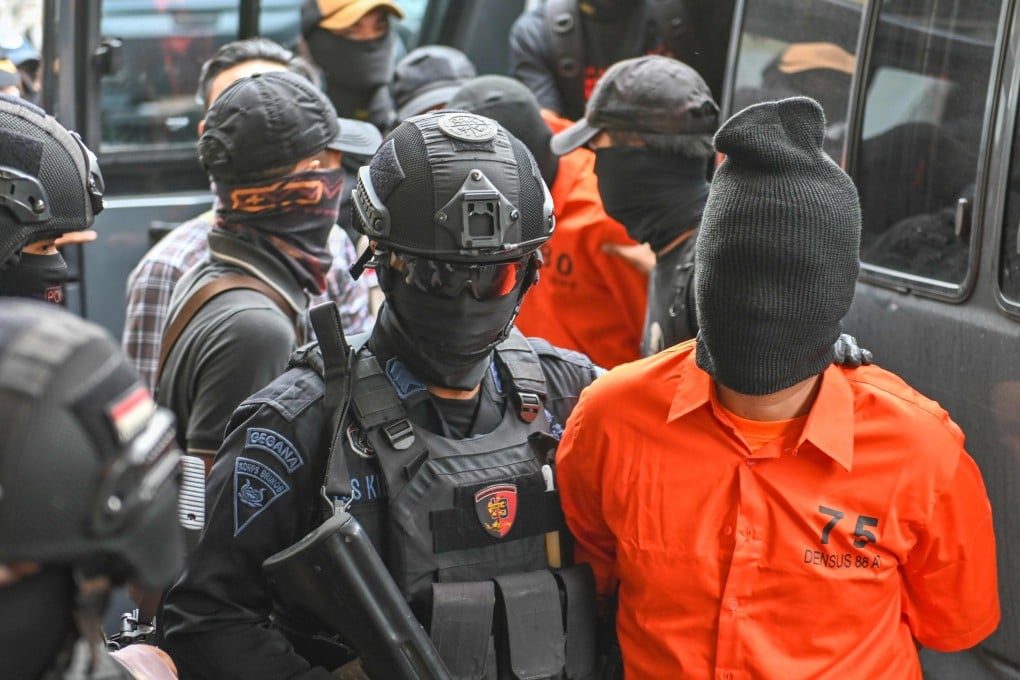 Indonesian police escort terror suspects to a news conference in Jakarta on May 17. Photo: AFP