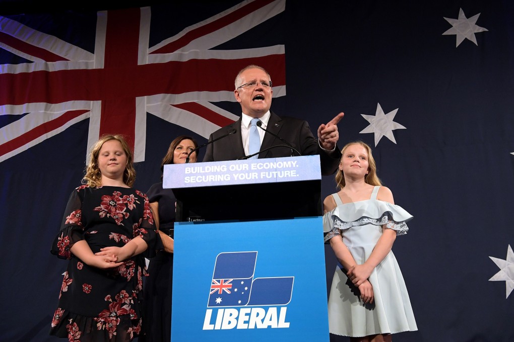 Prime Minister of Australia Scott Morrison, flanked by his wife Jenny Morrison and daughters Lily Morrison and Abbey Morrison, delivers his victory speech Saturday. Photo: TNS