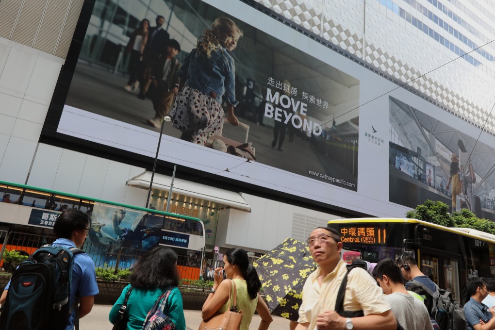 Cathay Pacific’s ad campaign is displayed on giant LCD screens at the Sogo department store in Causeway Bay. Photo: Felix Wong