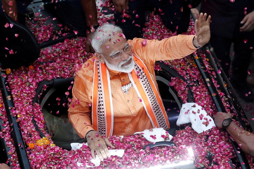 PM Narendra Modi waves to supporters in Varanasi on April 25. Photo: Reuters